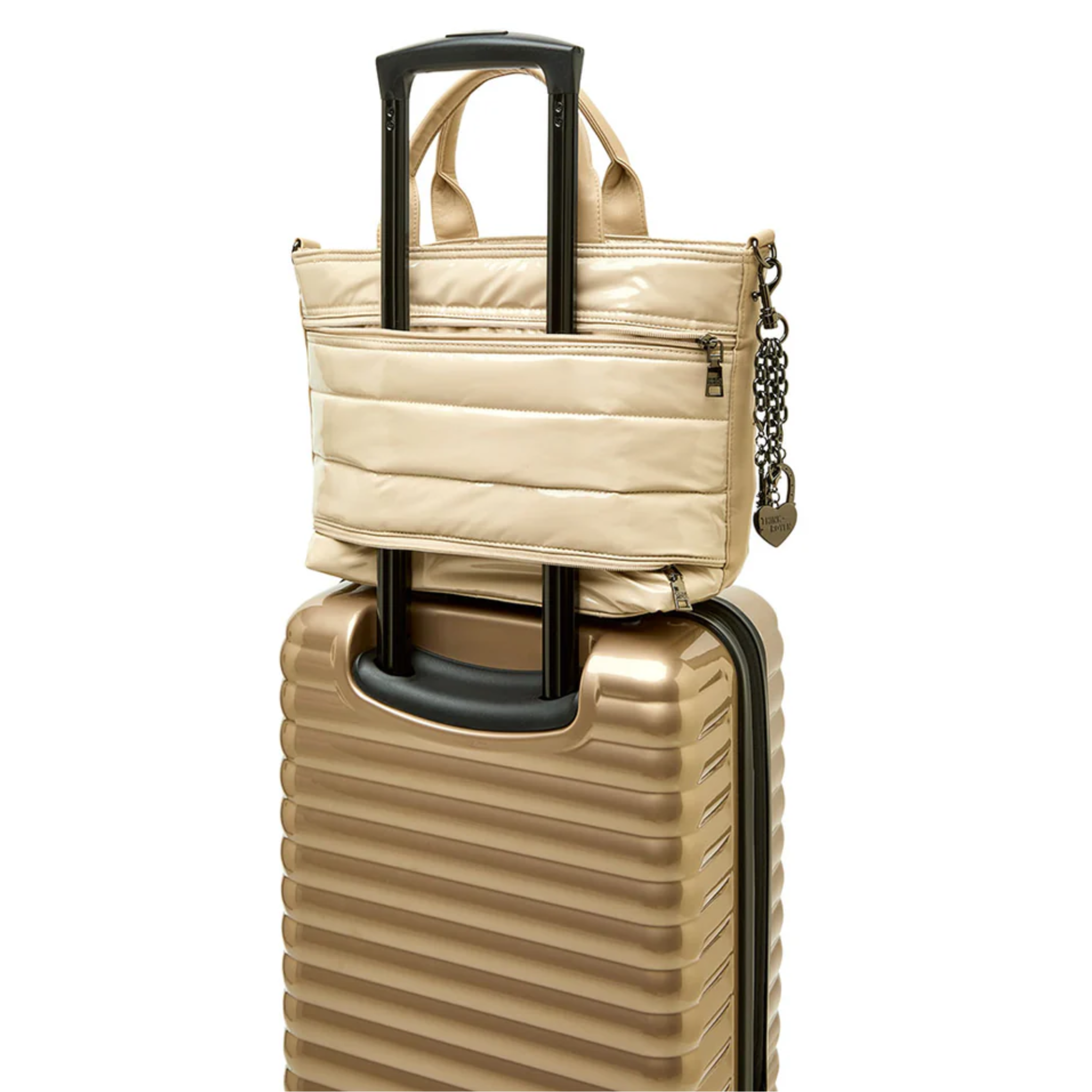 Travel bag charm featuring a heart and bow design from Think Royln's Getaway collection, displayed on a neutral background.