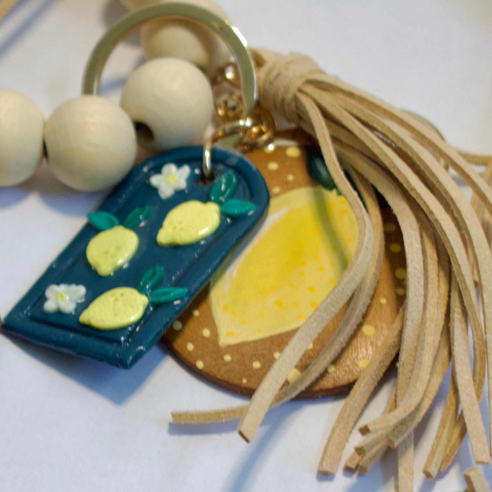 Hand painted ceramic key chain featuring a heart and bow design, by Gianna Valente x Lets Bag It.