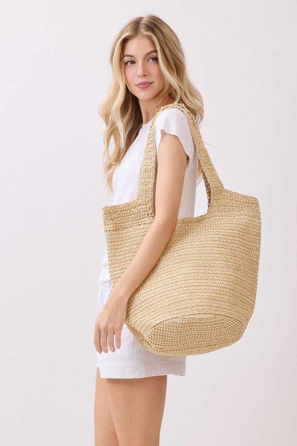 Handmade straw tote bag with leather handles from Private Label, featuring a natural woven texture and spacious design.