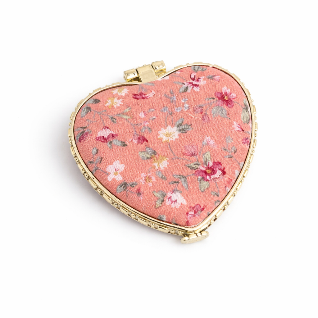 Compact floral mirror by Private Label, handheld with a floral pattern, perfect for travel and on-the-go use.