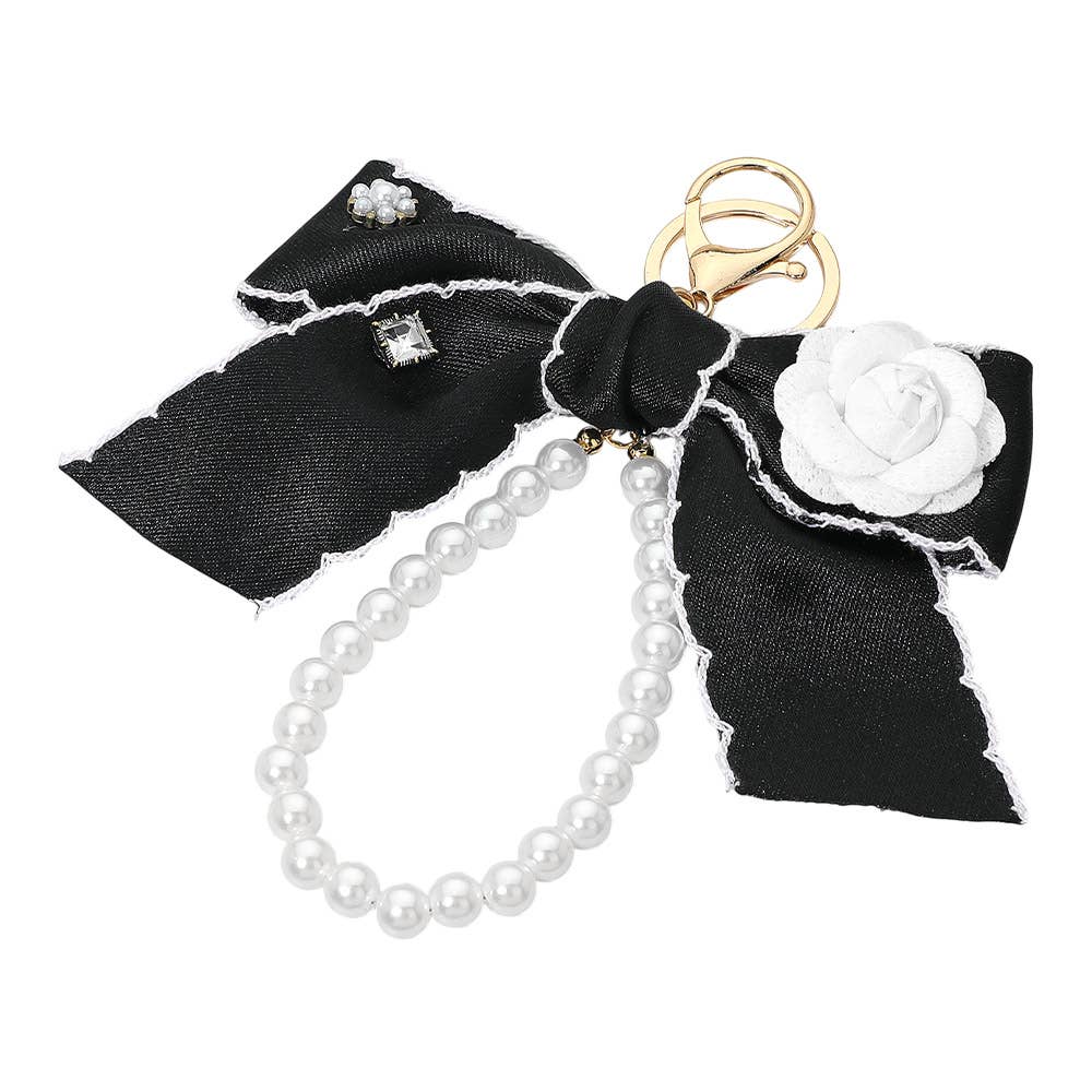 Flower rhinestone accent pearl loop bow keychain with decorative charms, perfect as a stylish bag accessory.