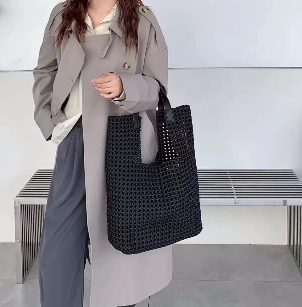 Black Eston woven tote handbag by Prenelove with sturdy handles and a textured woven design for casual or stylish use.