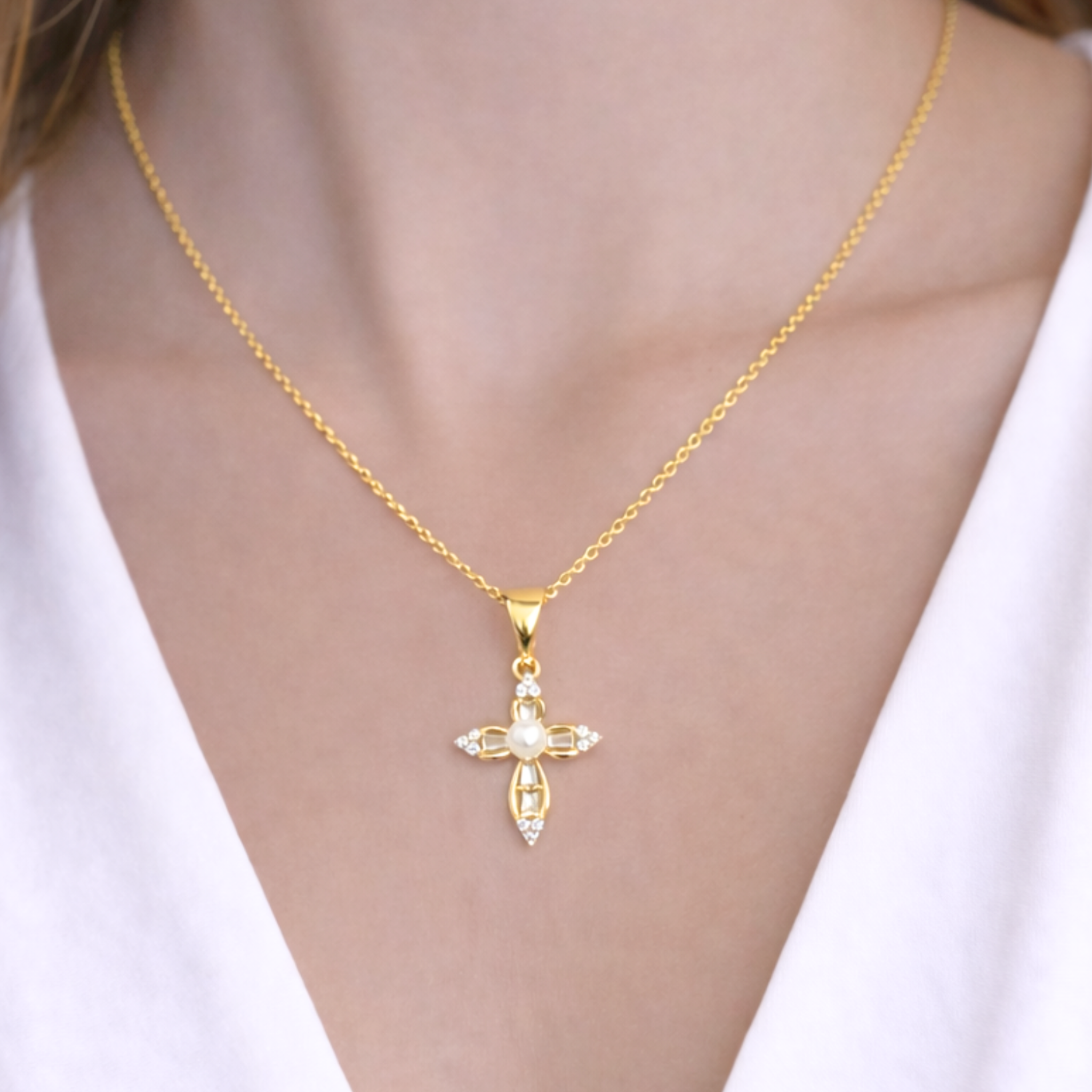 Private label pearled cross necklace with white pearls on a chain, close-up view of the elegant jewelry piece.